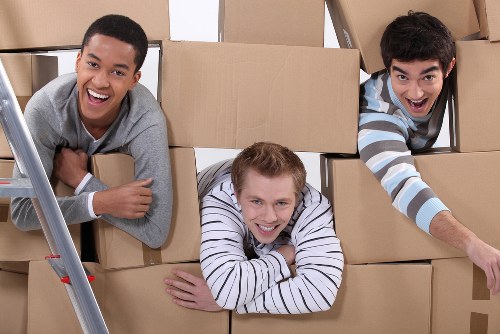 Local movers carrying furniture through a Pimlico apartment building